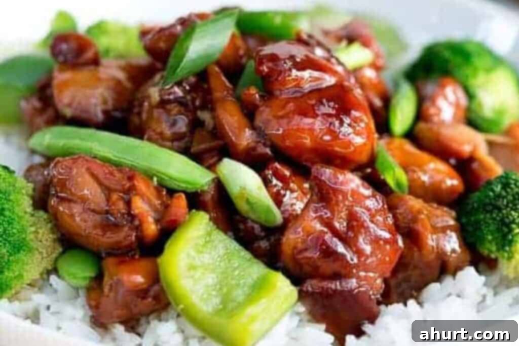 Quick and Delicious Teriyaki Chicken Stir Fry 7 Step 4: Combining the glazed chicken and cooked vegetables, garnished with fresh shallots, served over rice