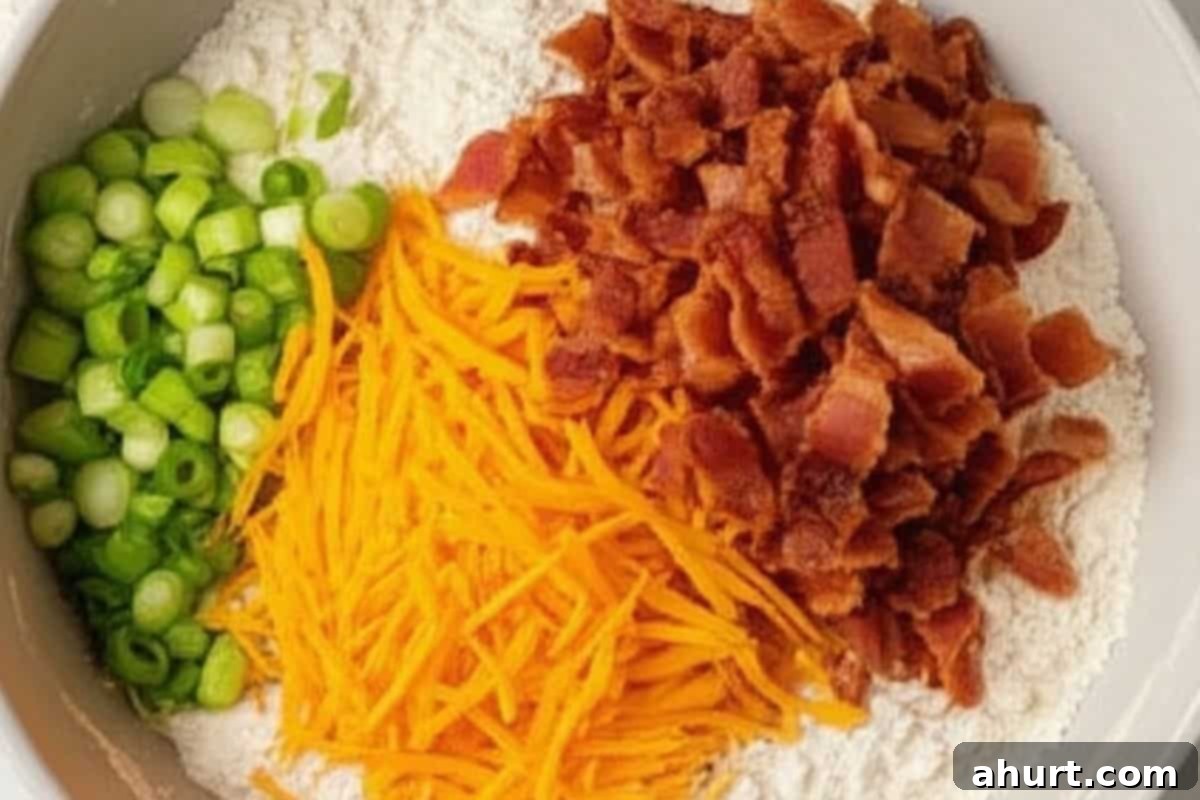 Fluffy Bacon Cheddar Delights 7 Stir the chopped bacon, shredded cheddar cheese, and sliced green onions into the chilled flour mixture.