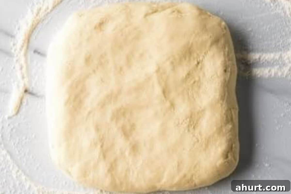 Fluffy Bacon Cheddar Delights 9 Knead the dough onto a floured surface and pat into an 8x8 inch square, then cut, stack, and re-roll.
