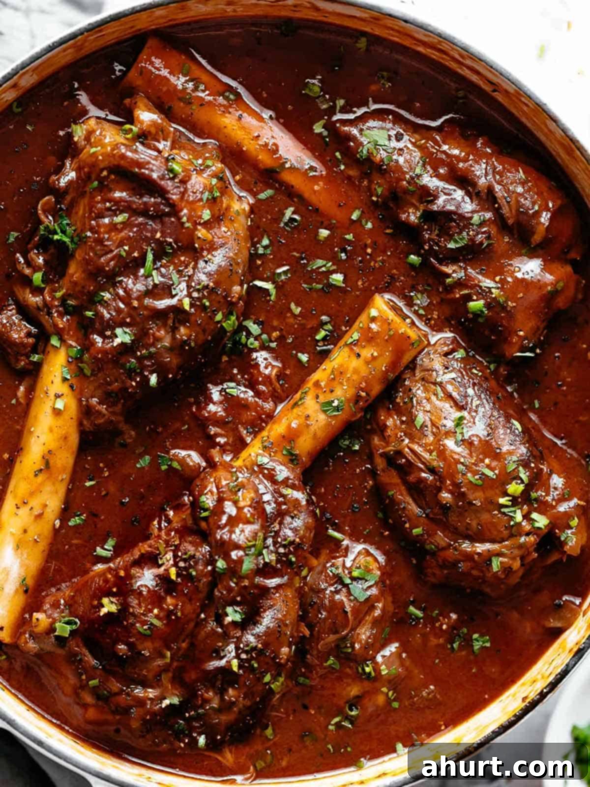 Fall-Off-The-Bone Lamb Shanks 2 Tender, fall off the bone easy braised Lamb Shanks in a luxuriously delicious red wine gravy! Can be Cooked in Oven or stove top or slow cooker or Instant pot.