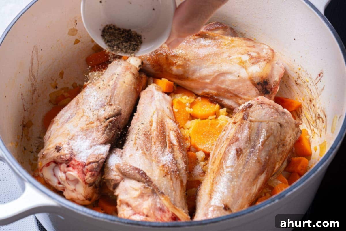 Fall-Off-The-Bone Lamb Shanks 7 Returning lamb shanks to the pot with sautéed vegetables, seasoned with salt and pepper.