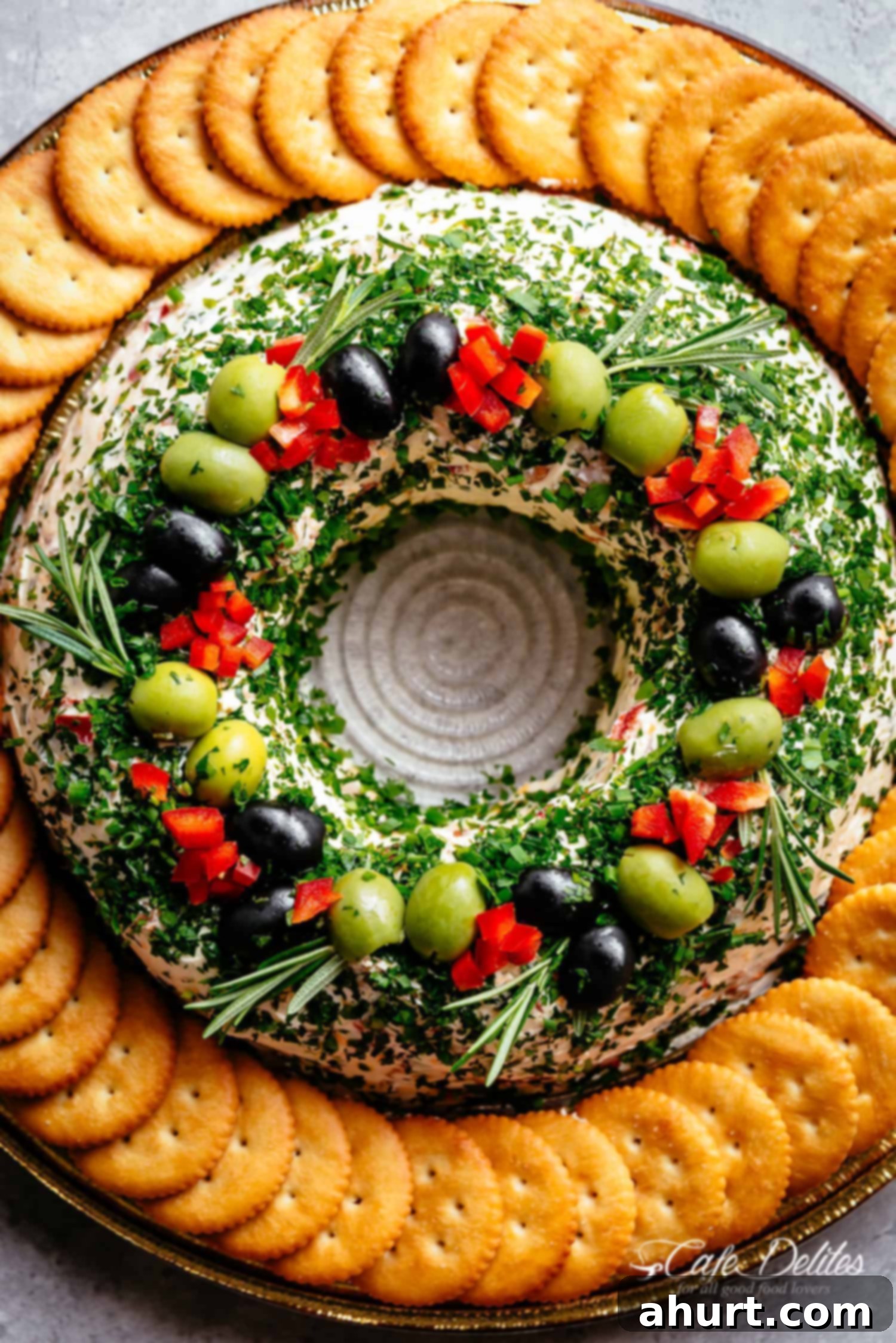 Christmas Bacon Cheese Ball Wreath with olives and crackers on a platter! Christmas Bacon Cheese ball Wreath Full of crispy bacon, cheese, chives and onions decorated with biscuits