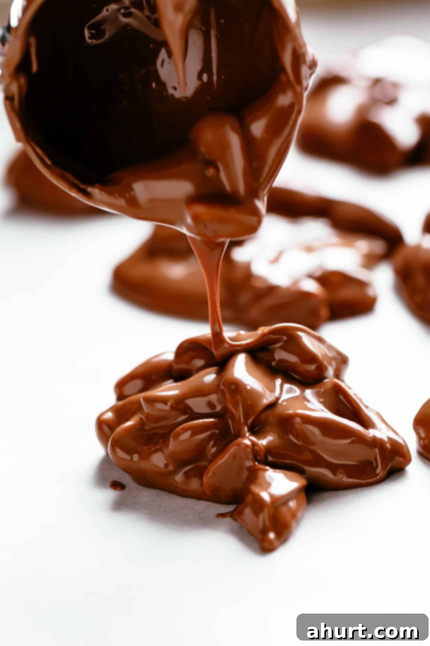 Making chocolate peanut clusters and dropping them onto a baking sheet.