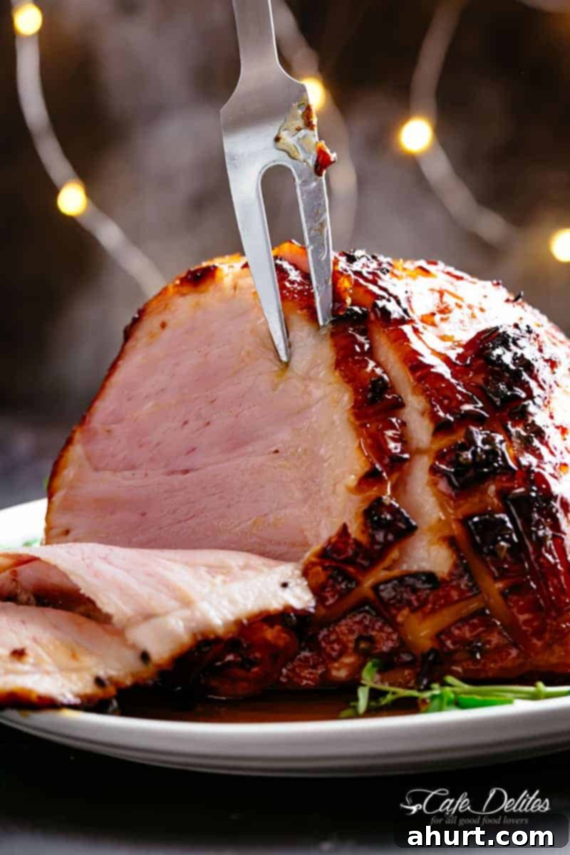 Carving Honey Baked Ham basted with pineapple juice and a buttery sticky glaze! #cafedelites #honey #honeybakedham #ham #bakedham #sliced Honey Baked Ham basted with a hint of pineapple juice and a buttery sticky glaze, Juicy and succulent on the inside with crispy, charred, sticky edges.