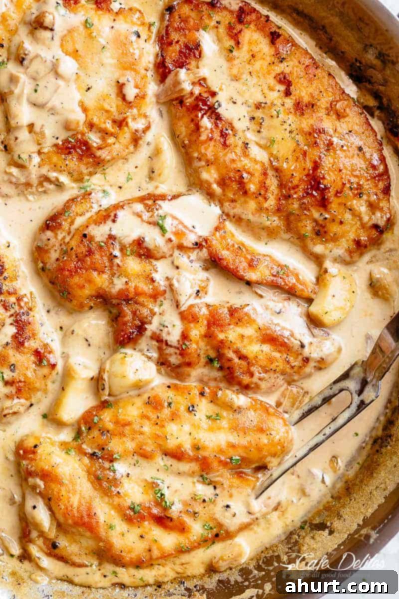 Chicken breast in a skillet with sauce #cafedelites #chicken #breast #skillet #garlic #cream #sauce Creamy Garlic Chicken Breasts simmering in a pan, rich and ready to serve.