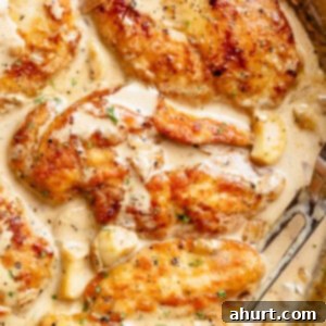 Irresistible Creamy Garlic Chicken Breasts 5 A close-up of a perfectly cooked Creamy Garlic Chicken Breast piece, showcasing its tender texture and rich sauce.