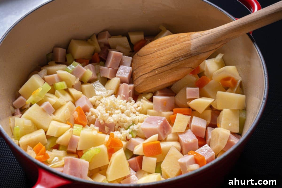 Rich Ham and Potato Chowder 4 Image of ham, garlic, and potatoes being added to the soffritto.
