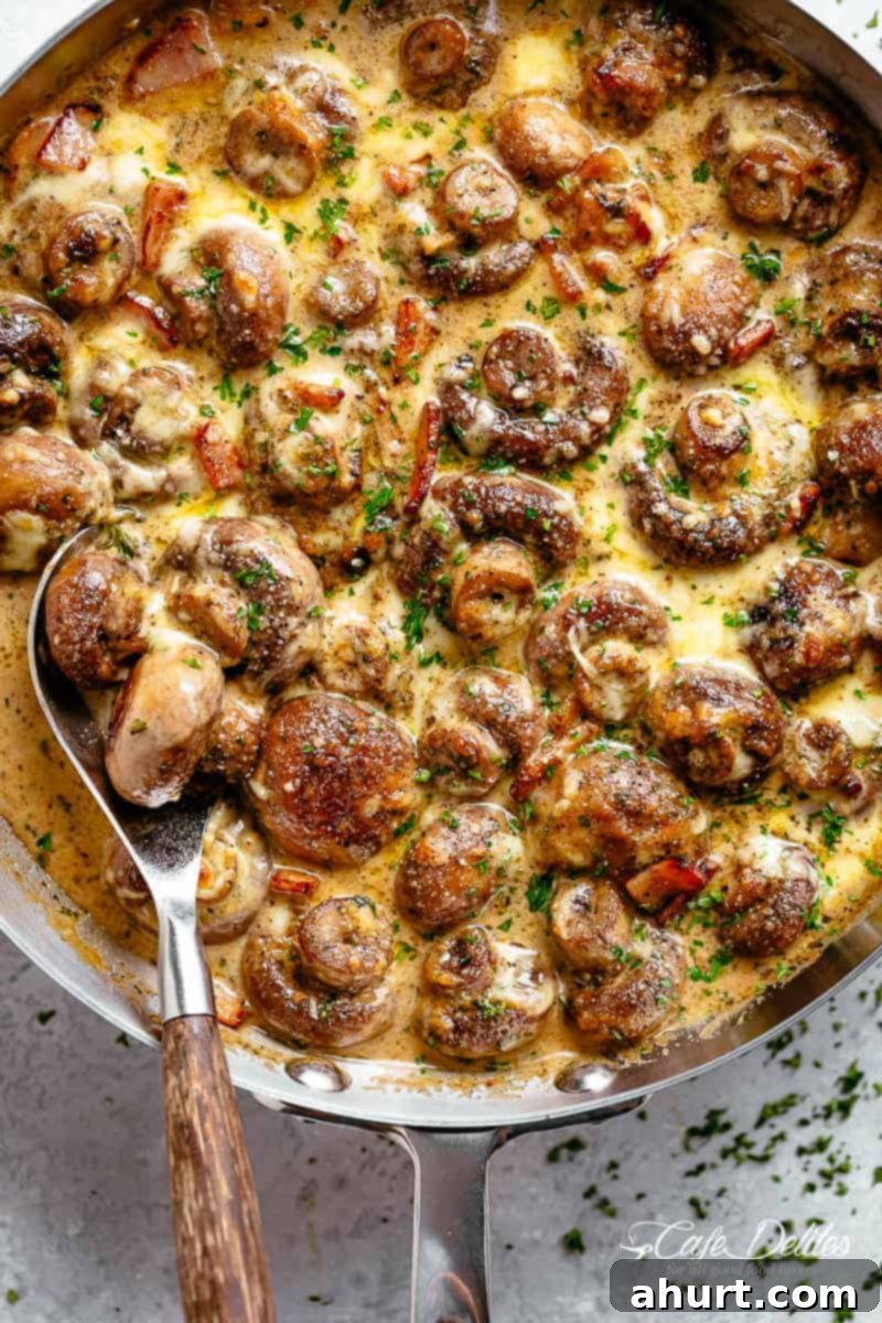 Mushroom recipe with cream sauce and bacon #cafedelites #bacon #mushrooms #recipe Creamy Garlic Mushrooms in a mouthwatering parmesan sauce with crispy bacon pieces and mozzarella cheese in a pan