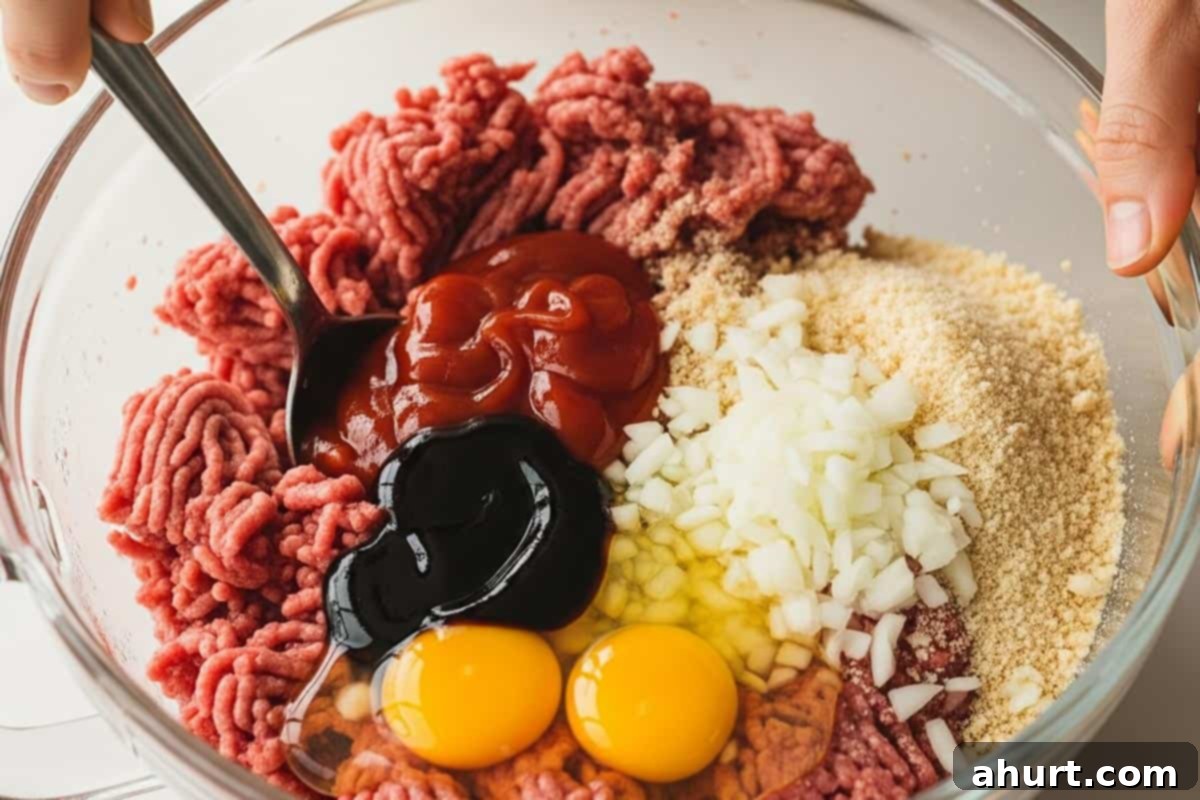 Tangy Glazed Party Meatballs 4 Beef, eggs, ketchup, Worcestershire sauce, breadcrumbs, and onion in a bowl.