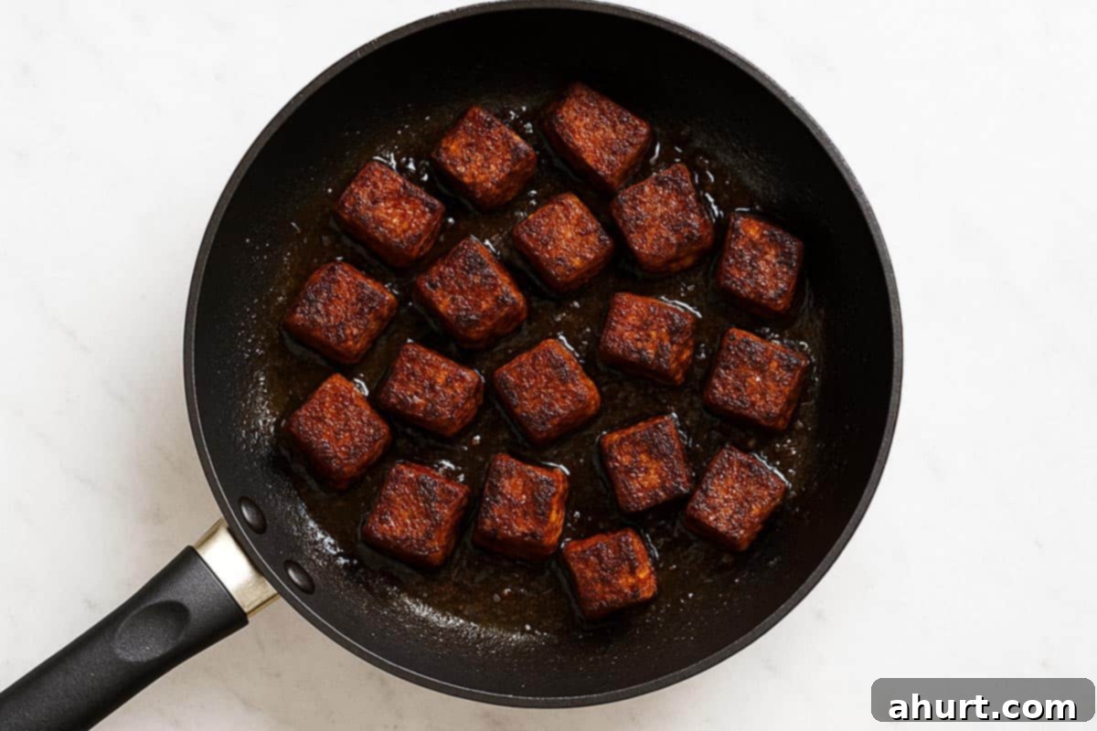 Irresistible Cajun Butter Steak Bites 6 seasoned steak being seared in a pan