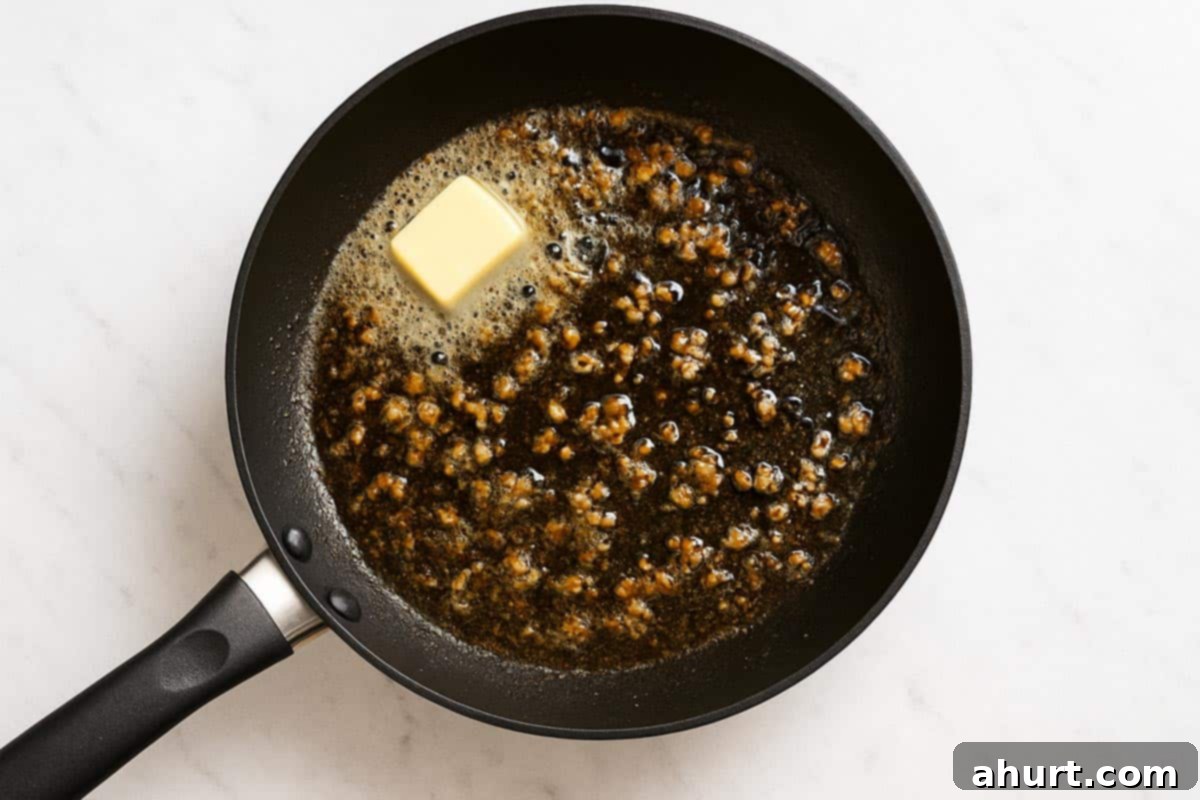 Irresistible Cajun Butter Steak Bites 7 garlic and butter being heated in a pan