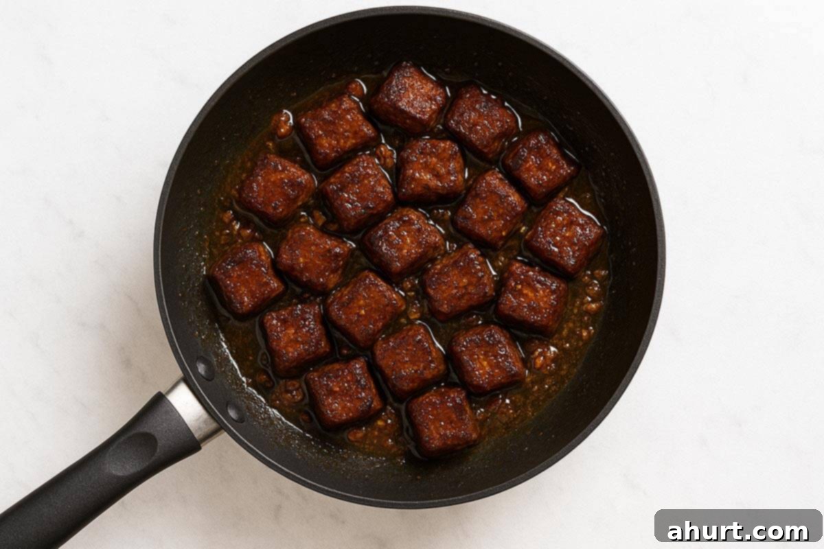 Irresistible Cajun Butter Steak Bites 8 steak, garlic and butter being heated in a pan.