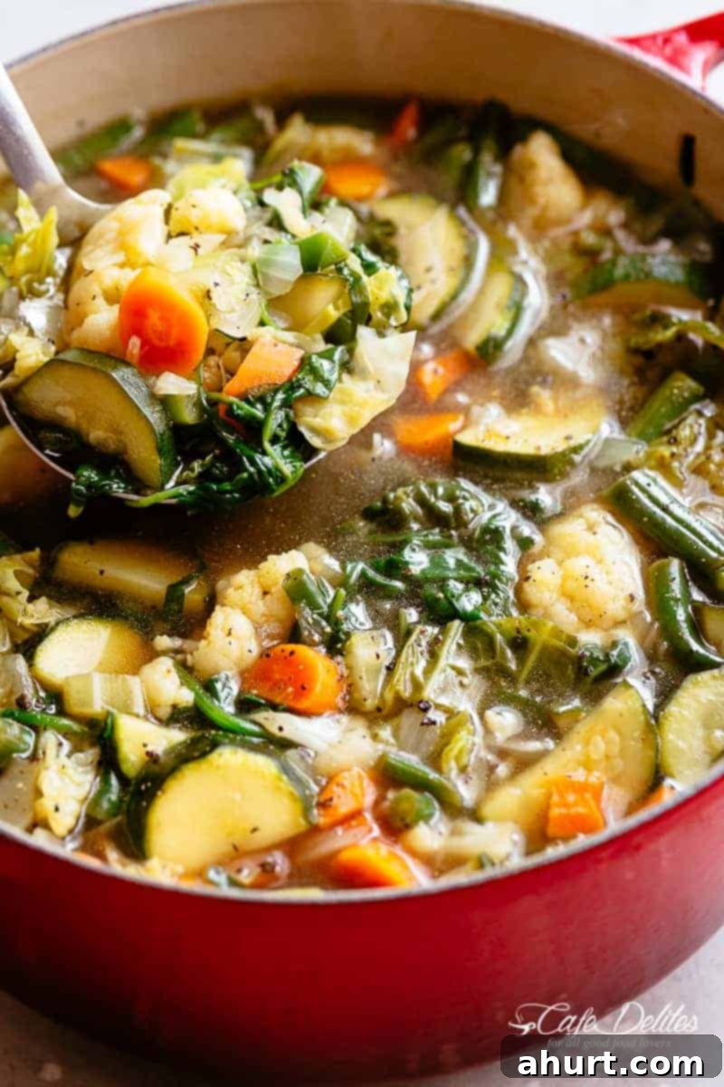 Vegetable Soup | cafedelites.com Zoom in image of A ladle scooping vegetable soup from a large pot.