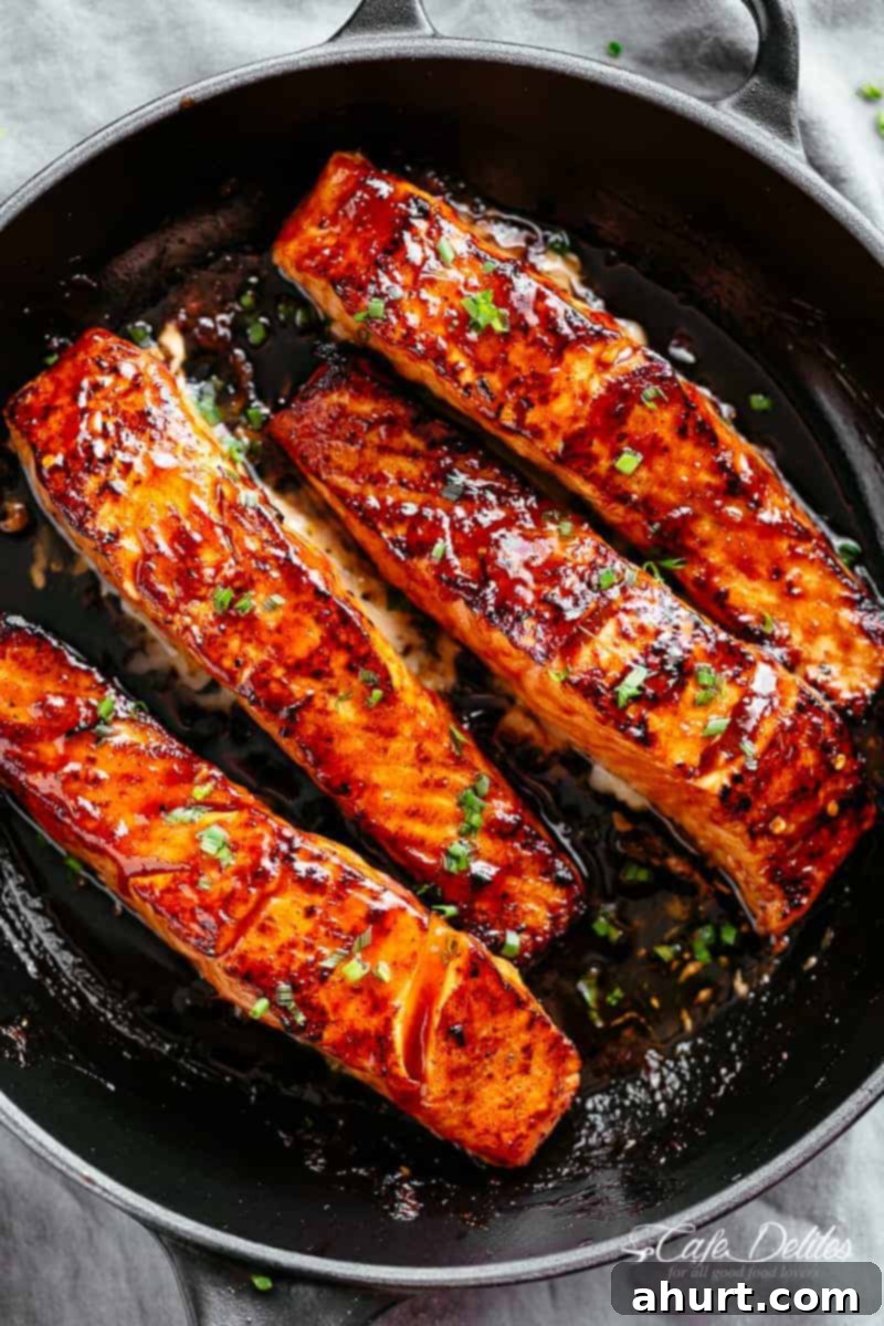 Salmon recipe pan seared oven baked #cafedelites #salmon #recipe Perfectly seared and oven-baked firecracker salmon on a plate, ready to be served.