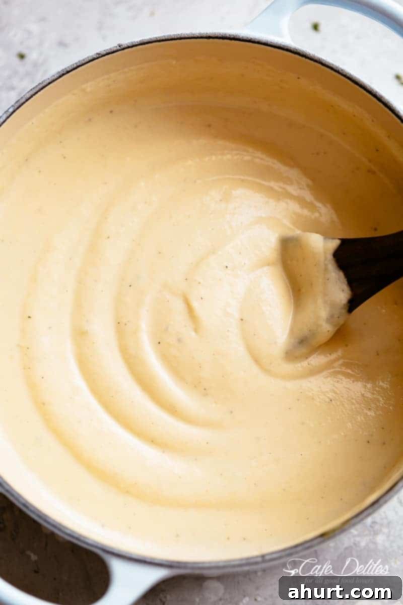 Creamy cauliflower soup in a Le Creuset round cast iron dutch oven #cafedelites #cauliflower #Keto Creamy Cauliflower Soup is low carb and blended with cream.