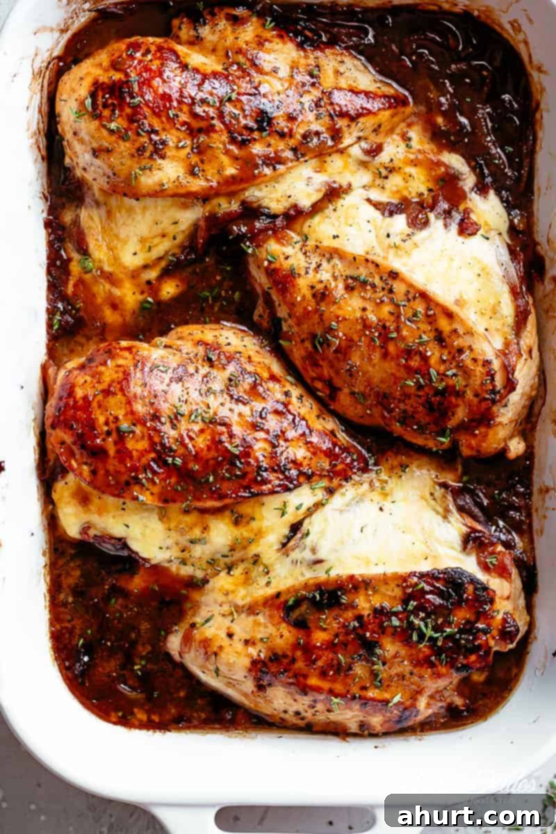 Stuffed Chicken with French onion #cafedelites #stuffedchicken #chicken #chickenrecipes #frenchonion #chickenbreasts Juicy French Onion Stuffed Chicken Casserole on a baking tray with golden crust and cheese