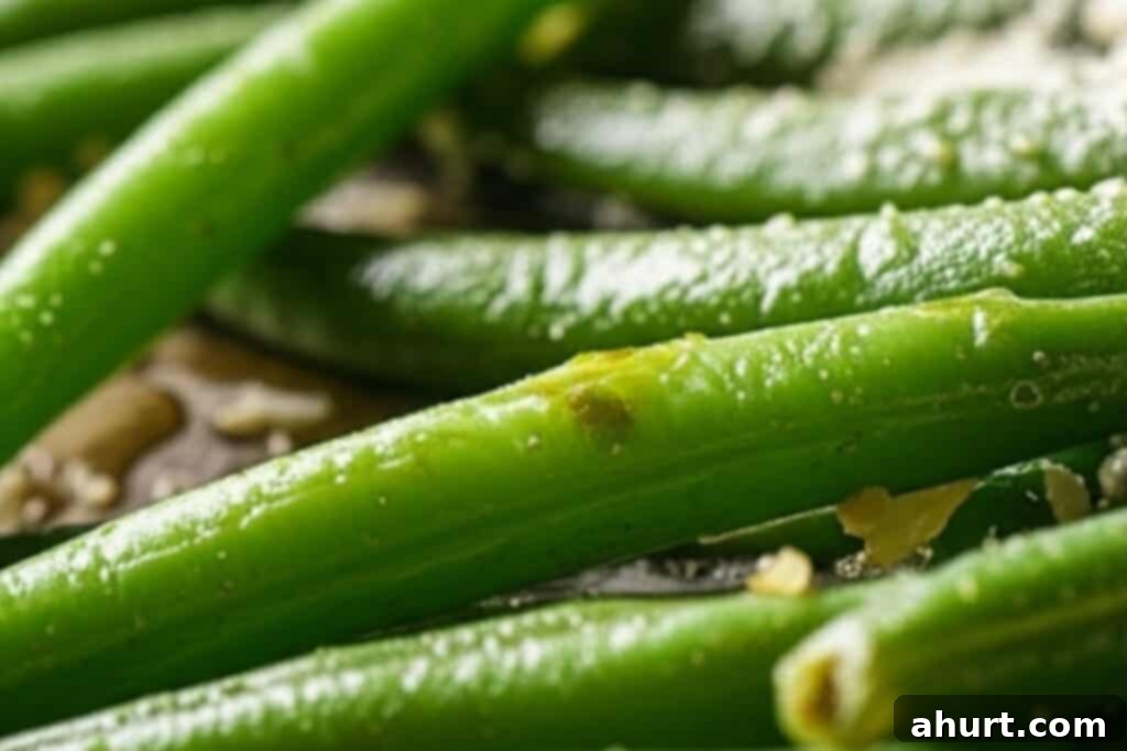 Parmesan Garlic Green Beans 5 Step 3: Roasted green beans in the oven, halfway through cooking.