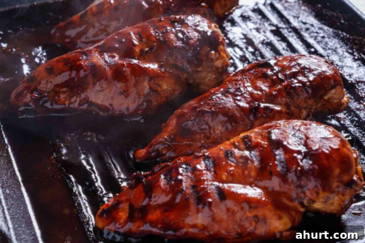 Zesty Garlic-Lime Grilled Chicken Salad 5 chicken breasts covered in sauce being grilled until cooked through.