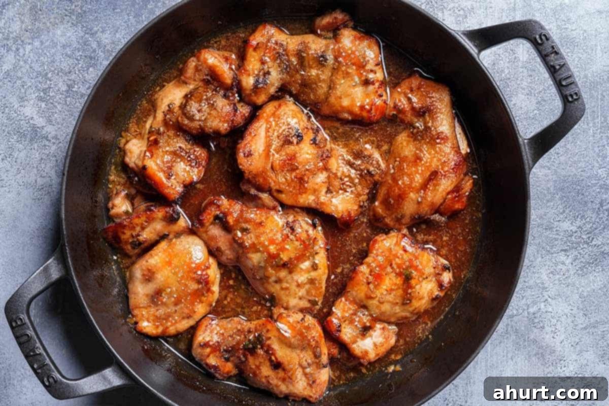 Honey Soy Glazed Chicken Thighs 7 Image of the chicken being taken out of the oven after having been broiled.