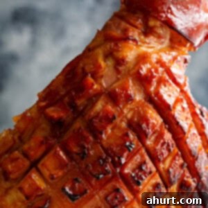 Caramelized Maple Ham 8 Baked Maple Glazed Ham with a rich, sticky glaze, garnished for a holiday table.