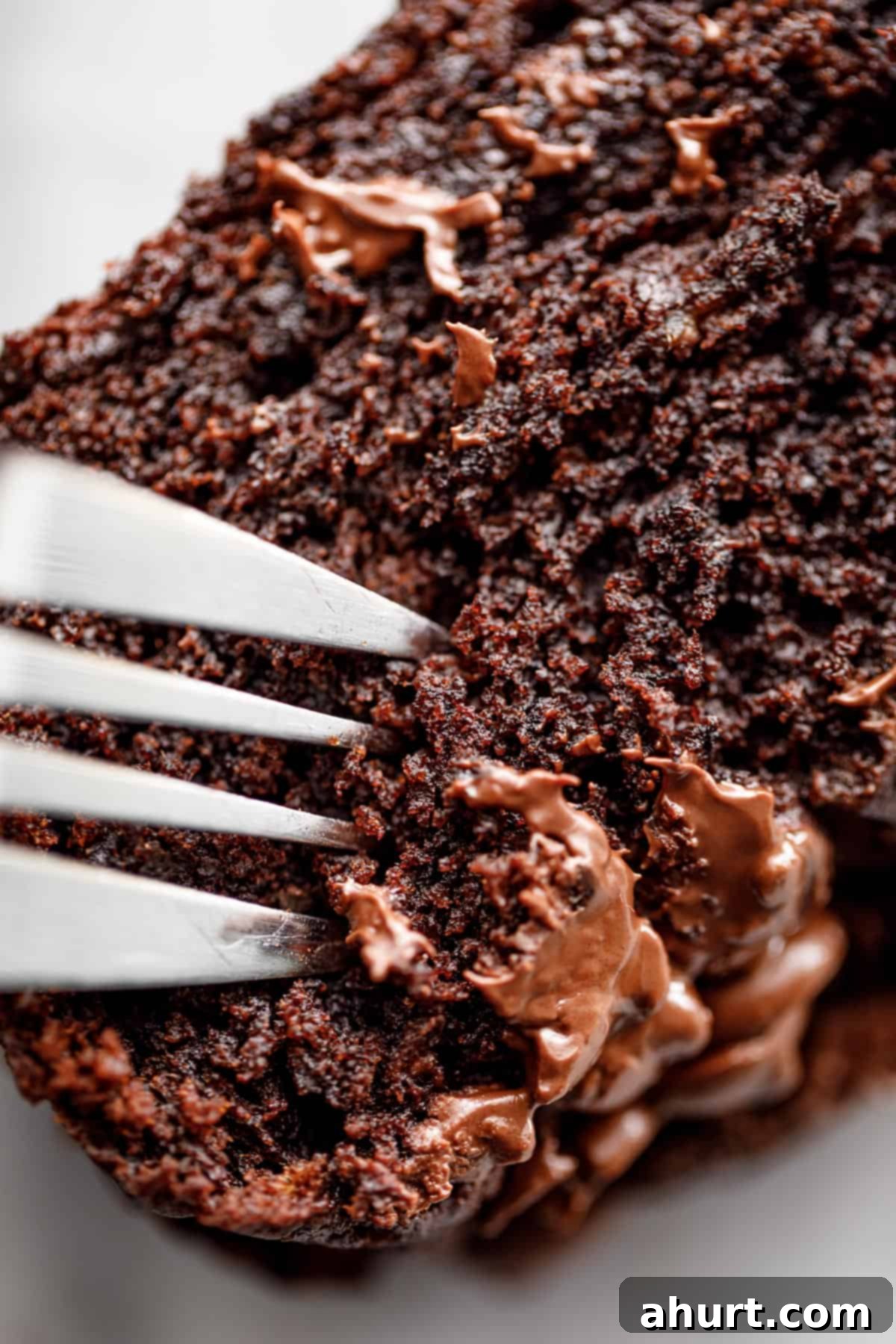 Decadent Double Chocolate Banana Loaf 10 Super soft banana bread Served with a fork, showing its moist and tender crumb.