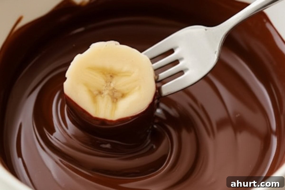 Chocolate-Dipped Banana Heaven 7 Dip one banana slice at a time into the melted chocolate.