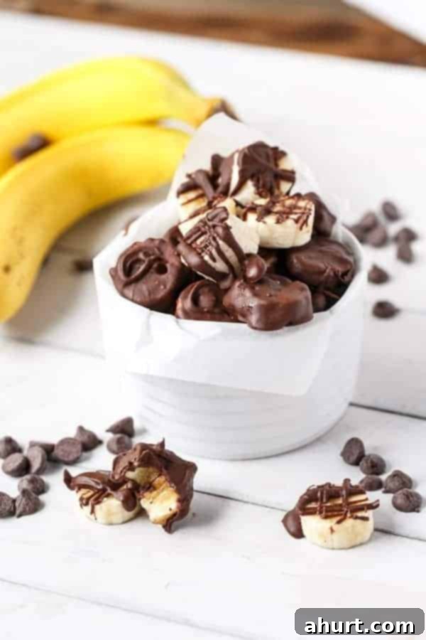 Chocolate-Dipped Banana Heaven 10 Side view image of Chocolate Covered Bananas, showing the thickness of the chocolate layer and appealing presentation.