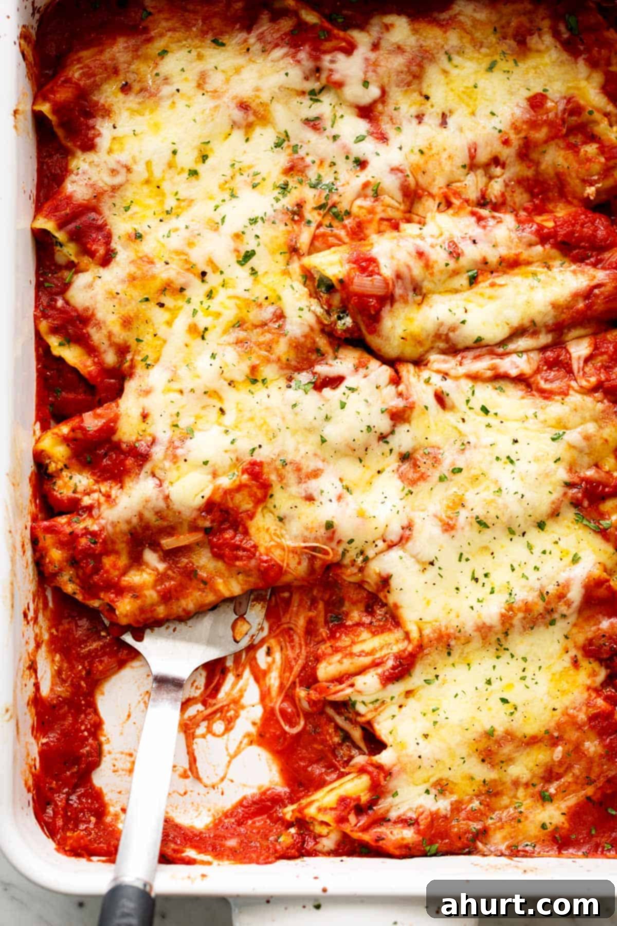 Baked Spinach Manicotti 2 Top view of Cheesy Spinach Ricotta Manicotti (Cannelloni) in a baking dish, fresh out of the oven, ready to serve.