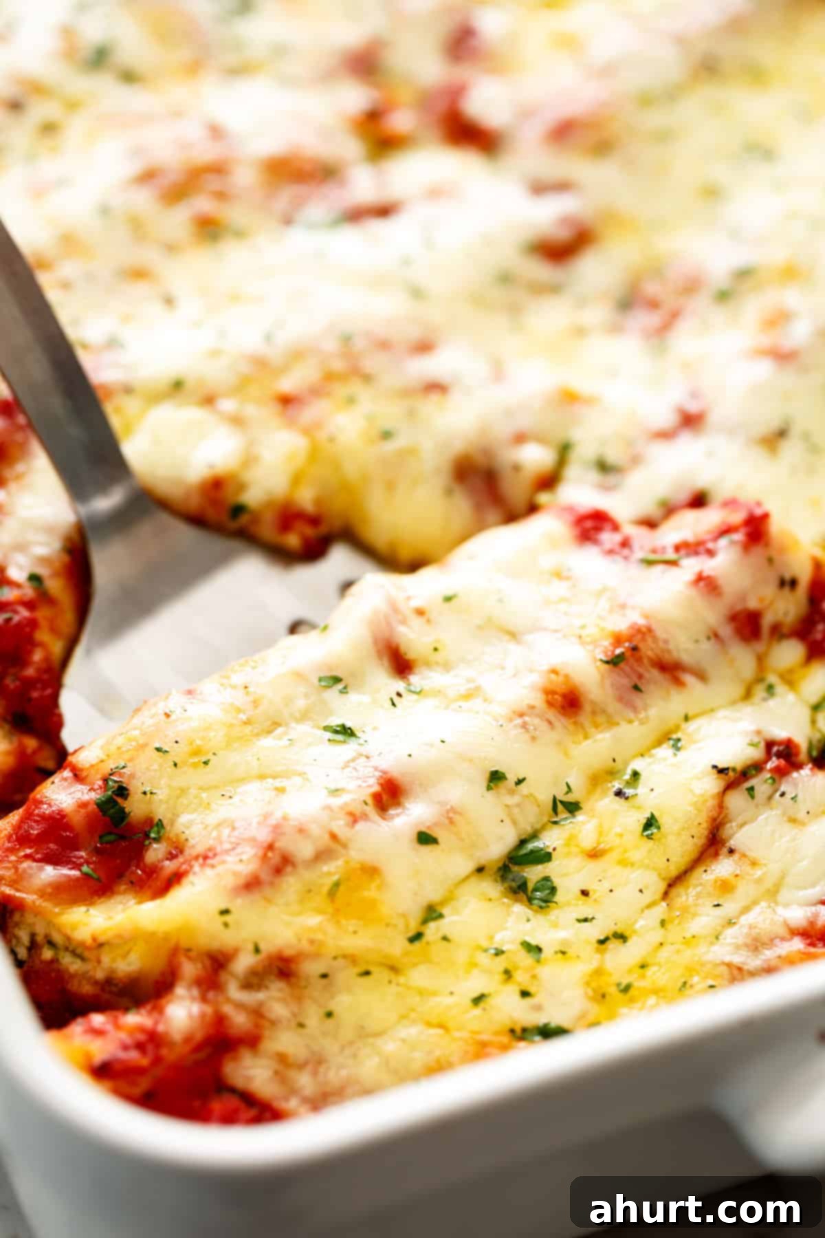 Baked Spinach Manicotti 12 Close-up of cheesy Spinach Ricotta Manicotti on a fork, showing the creamy filling and melted cheese.