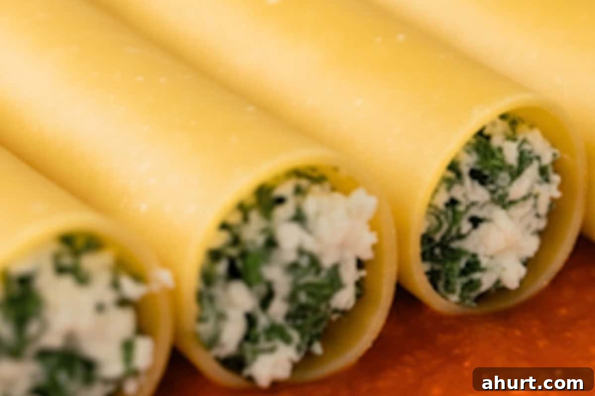 Baked Spinach Manicotti 9 Transferring spinach ricotta filling into a piping bag, then draining softened manicotti shells and piping the filling inside, arranging them in a single layer in the baking dish.