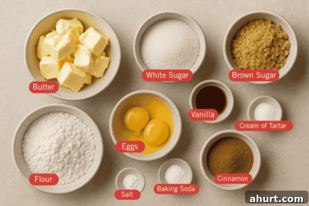 Classic Snickerdoodle Cookies 3 Flatlay image of labeled snickerdoodle cookie ingredients in small bowls on a neutral surface. Ingredients include butter, white sugar, brown sugar, flour, eggs, vanilla, cream of tartar, cinnamon, baking soda, and salt