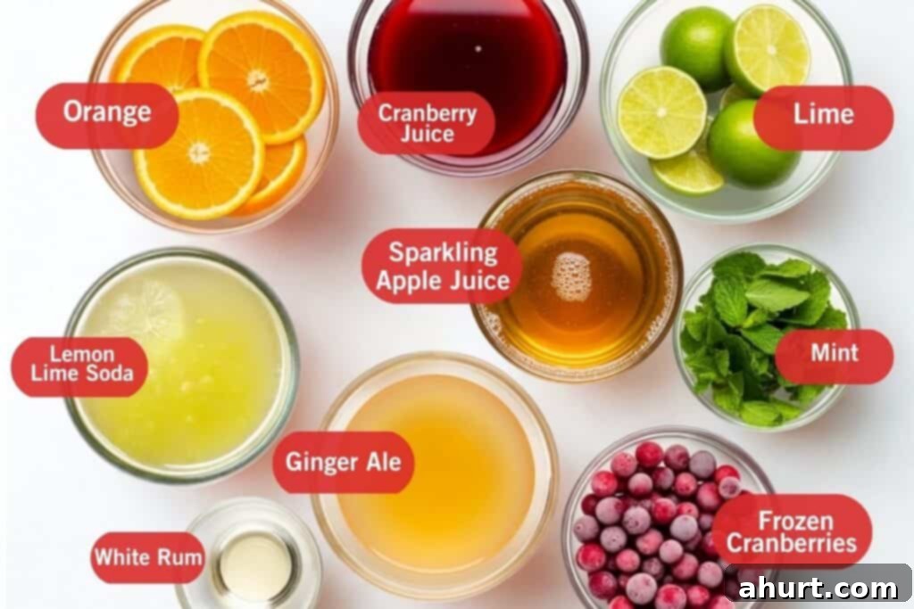 Festive Holiday Punch 3 Flatlay arrangement of ingredients for Holiday Punch, including cranberry juice, sodas, rum, citrus, mint, and frozen cranberries