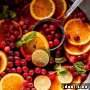 Festive Holiday Punch 7 Vibrant Mixed Fruit Holiday Punch in a large glass bowl