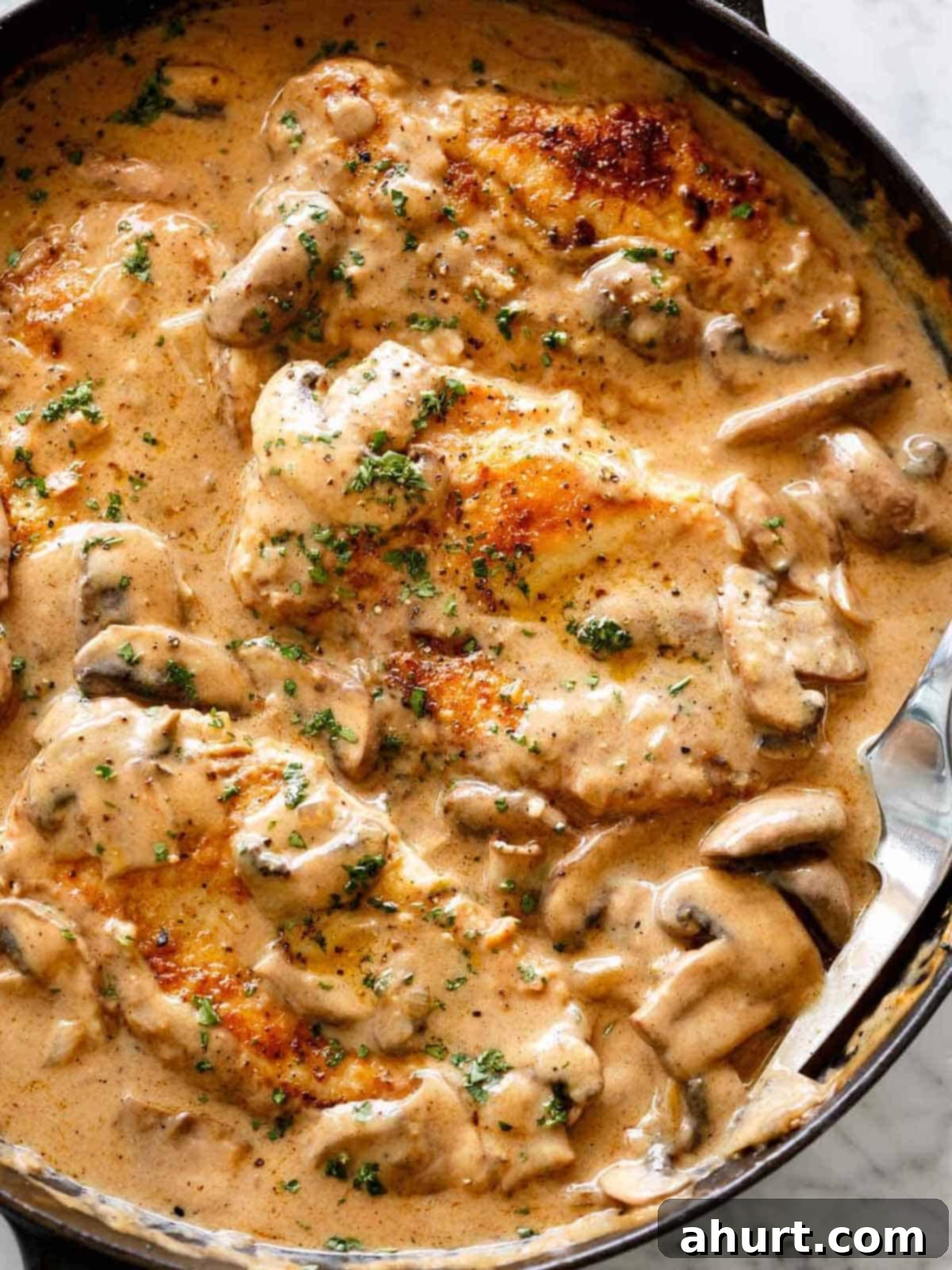 Chicken Stroganoff is just like beef stroganoff, but better! #chicken #chickenbreast #stroganoff #recipe creamy Chicken Stroganoff in a creamy mushroom gravy inside a black pan