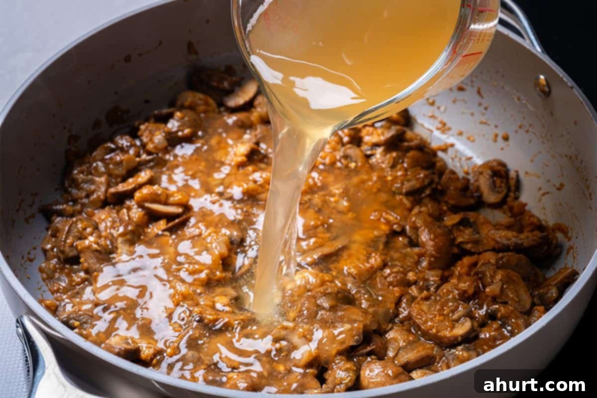 Chicken Stroganoff 7 mushrooms and seasonings with stock and wine in a pan with flour
