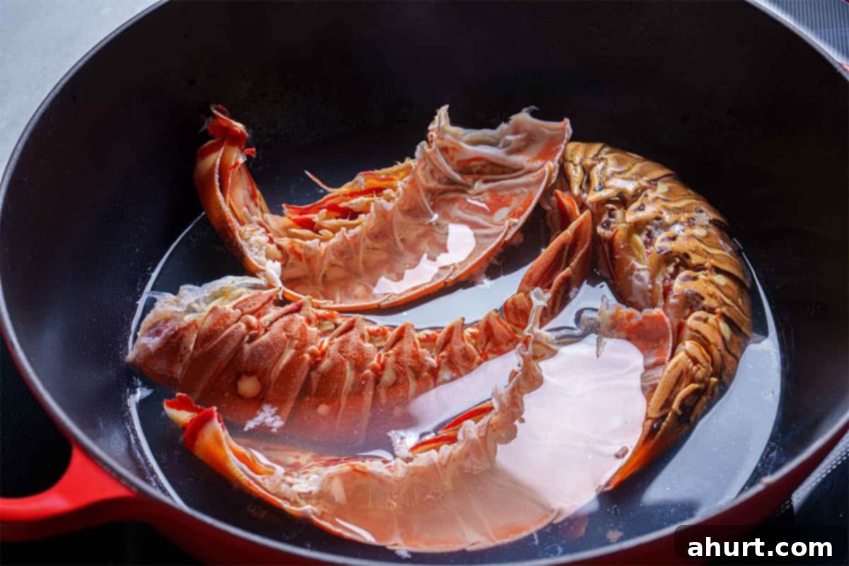 Luxurious Lobster Bisque 6 Empty lobster shells being returned to the pot with the reserved cooking liquid to simmer and extract maximum flavor for the homemade stock.