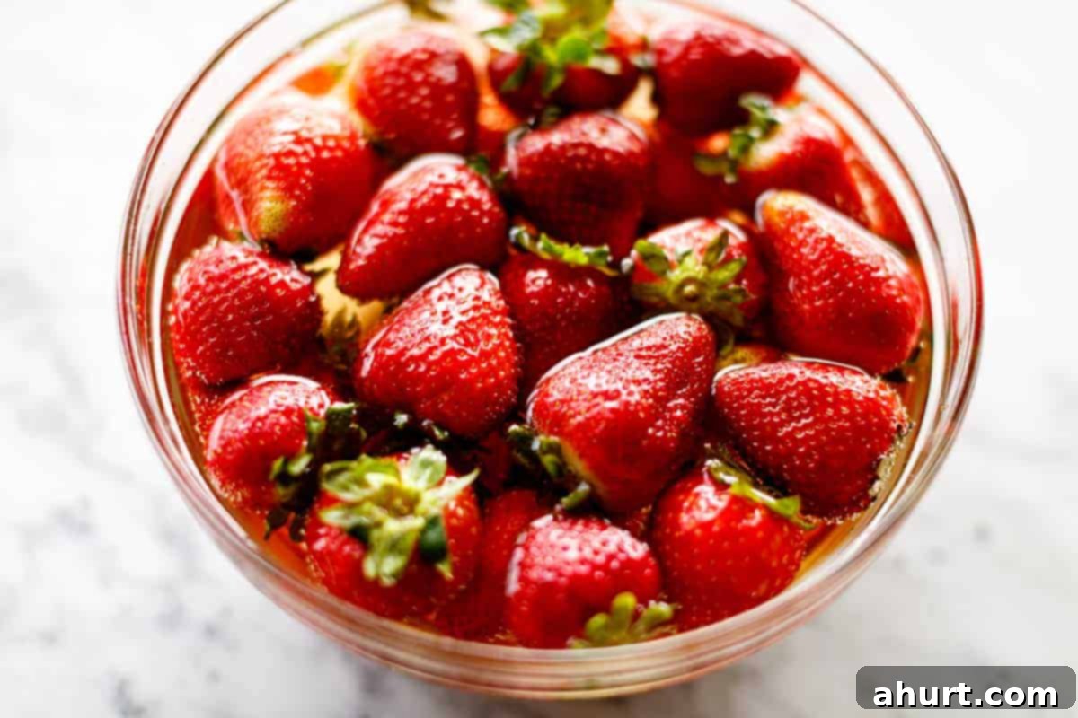 Chocolate-Dipped Strawberries 3 A bowl of fresh strawberries soaking in alcohol.