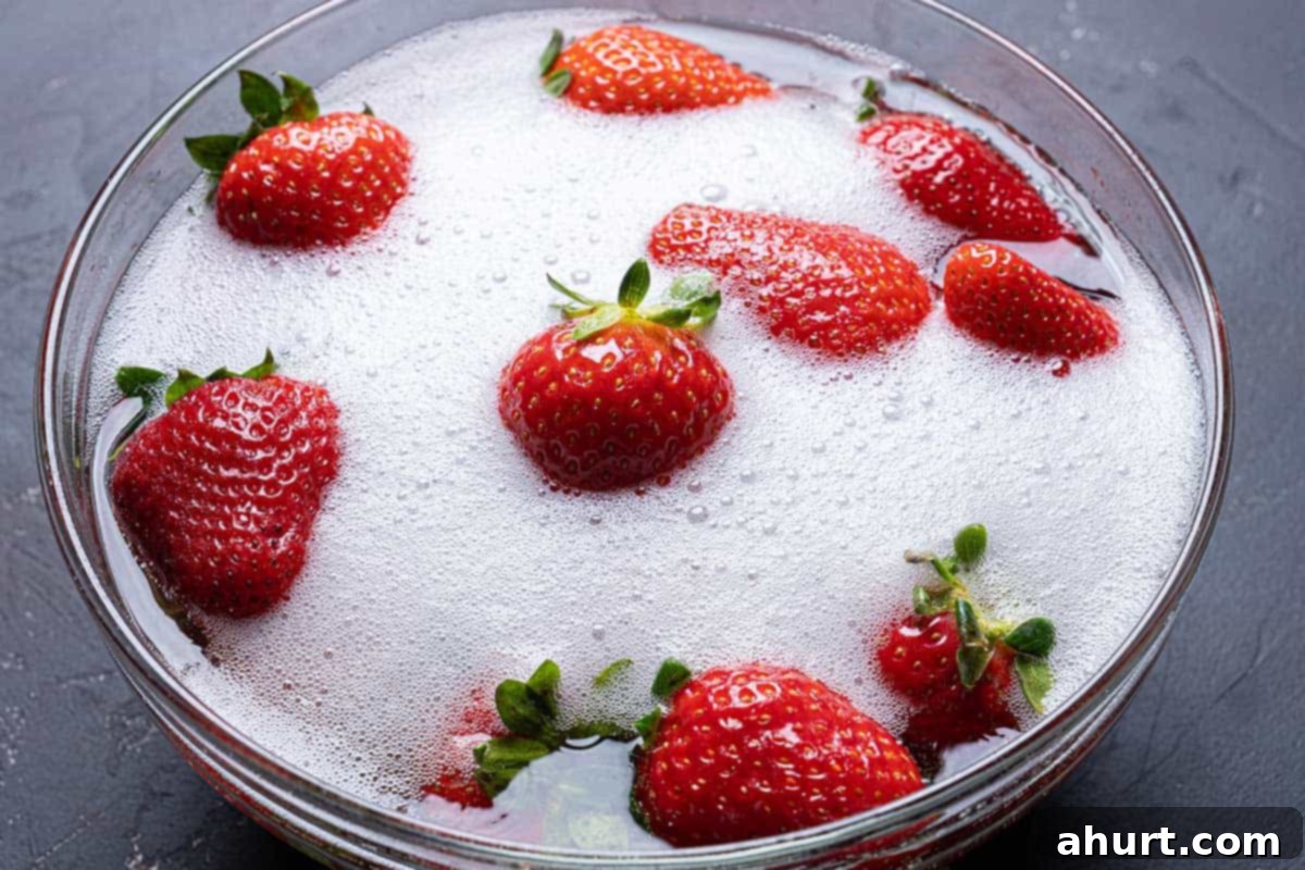 Decadent Champagne Strawberries Infused With Your Favorite Spirit 3 Fresh, vibrant strawberries soaking in a generous pool of sparkling champagne within a large glass bowl.
