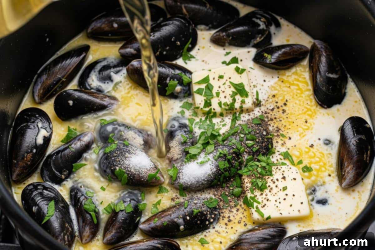 Moules Marinières French Bistro Classic 5 mussels, heavy cream, butter, chopped parsley, salt and pepper in a pot with white wine being poured.