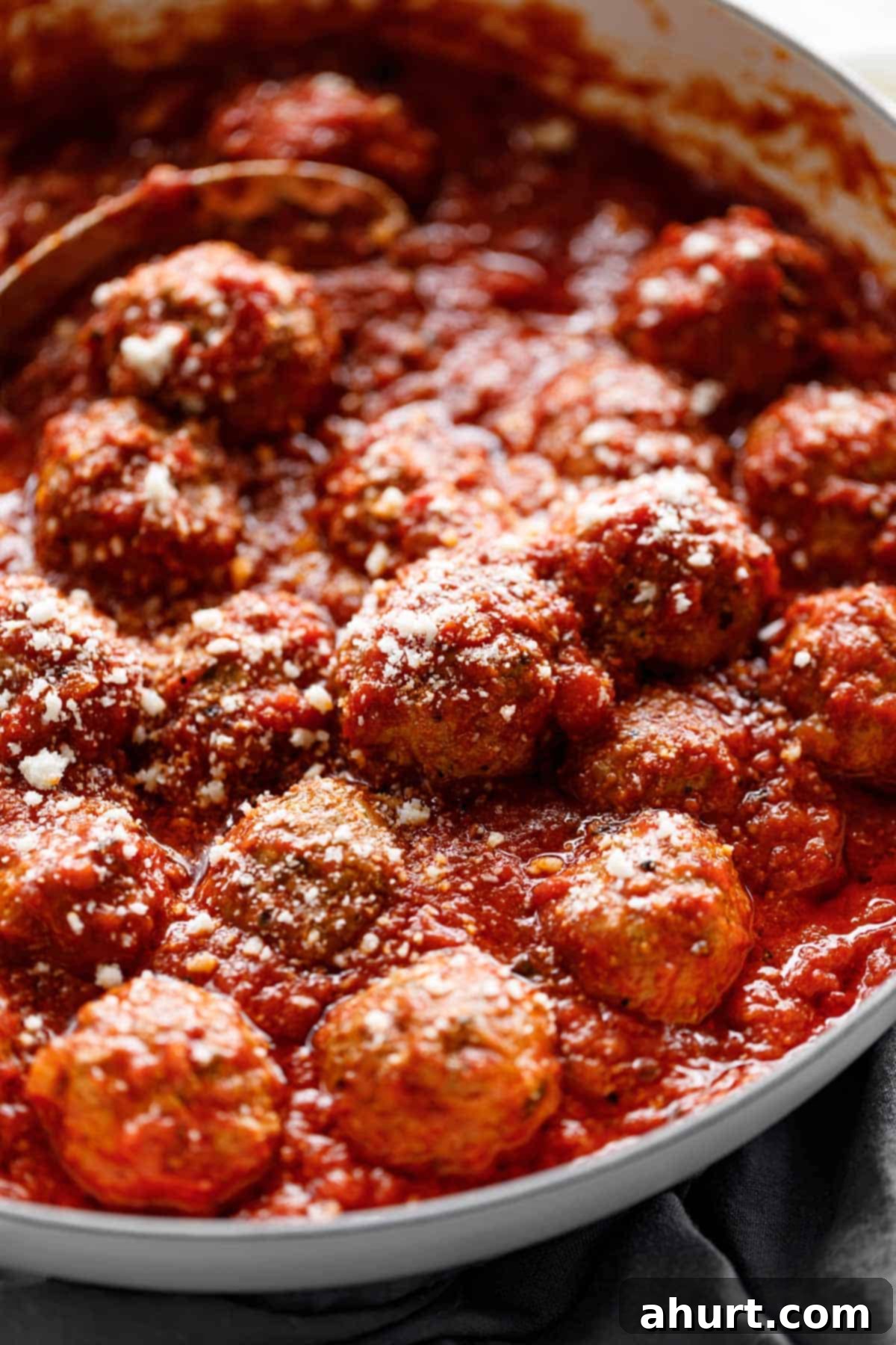 Italian Baked Meatballs in a tomato sauce #meatballs #baked #marinara #tomato #sauce #delicious Easy Baked Meatballs soaked in a vibrant tomato marinara sauce, ready to serve.