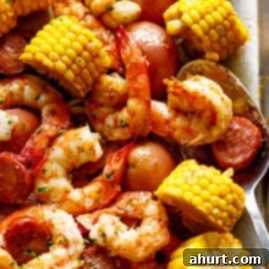 Shrimp Shindig 2 zoom in image of Shrimp boil on a tray with a tablespoon.