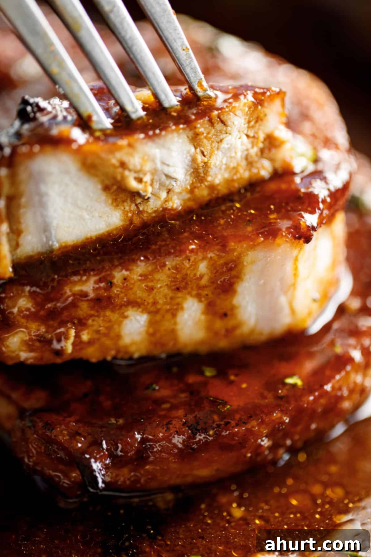Tender Baked BBQ Pork Chops 5 Juicy sliced BBQ pork chops drizzled with extra sauce, ready to serve.