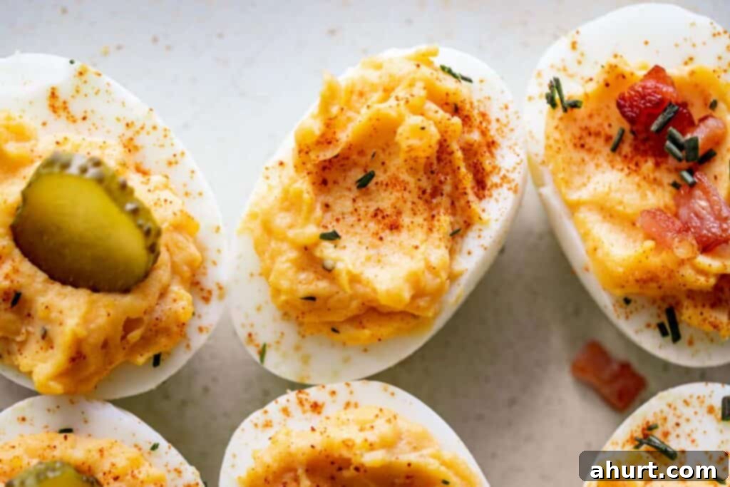Timeless Deviled Eggs 12 Deviled Eggs with different toppings like bacon, chives, and paprika, showcasing variety.