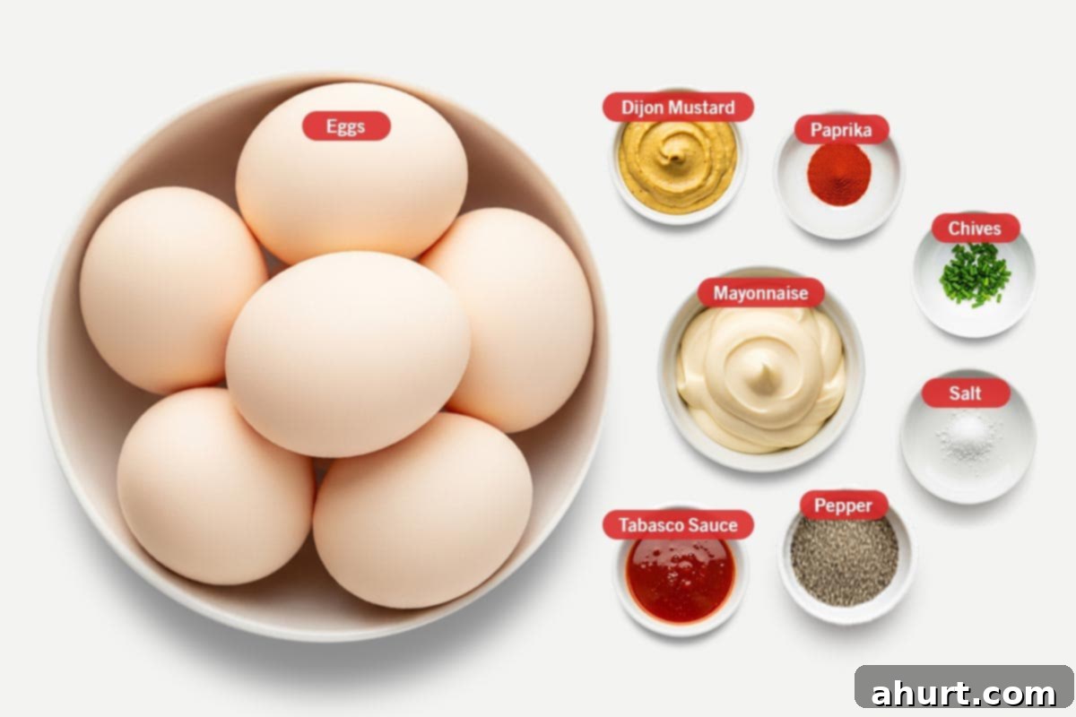 Timeless Deviled Eggs 3 Top shot of ingredients: Eggs, Mayonnaise, Dijon Mustard, Tabasco Sauce, Paprika, Chives, Salt, Pepper arranged neatly on a surface.