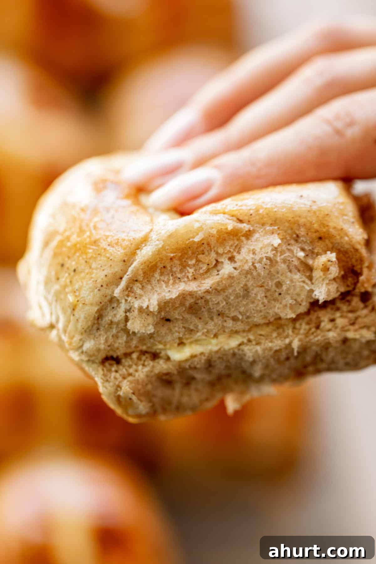 Spiced Easter Indulgence 3 Holding Hot Cross Buns in fingers