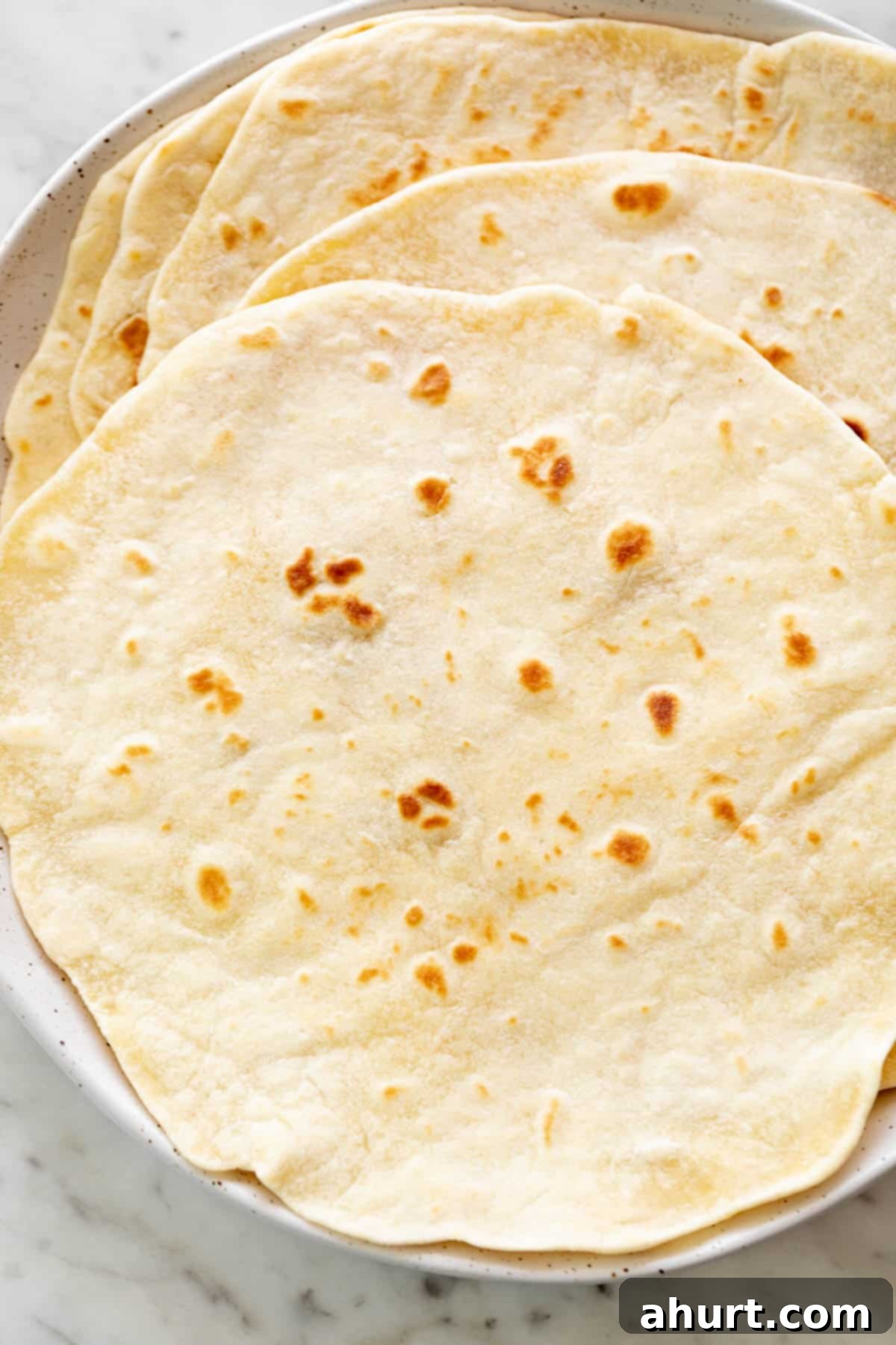 Perfect Homemade Flour Tortillas 2 Flour fresh Tortillas on a plate.