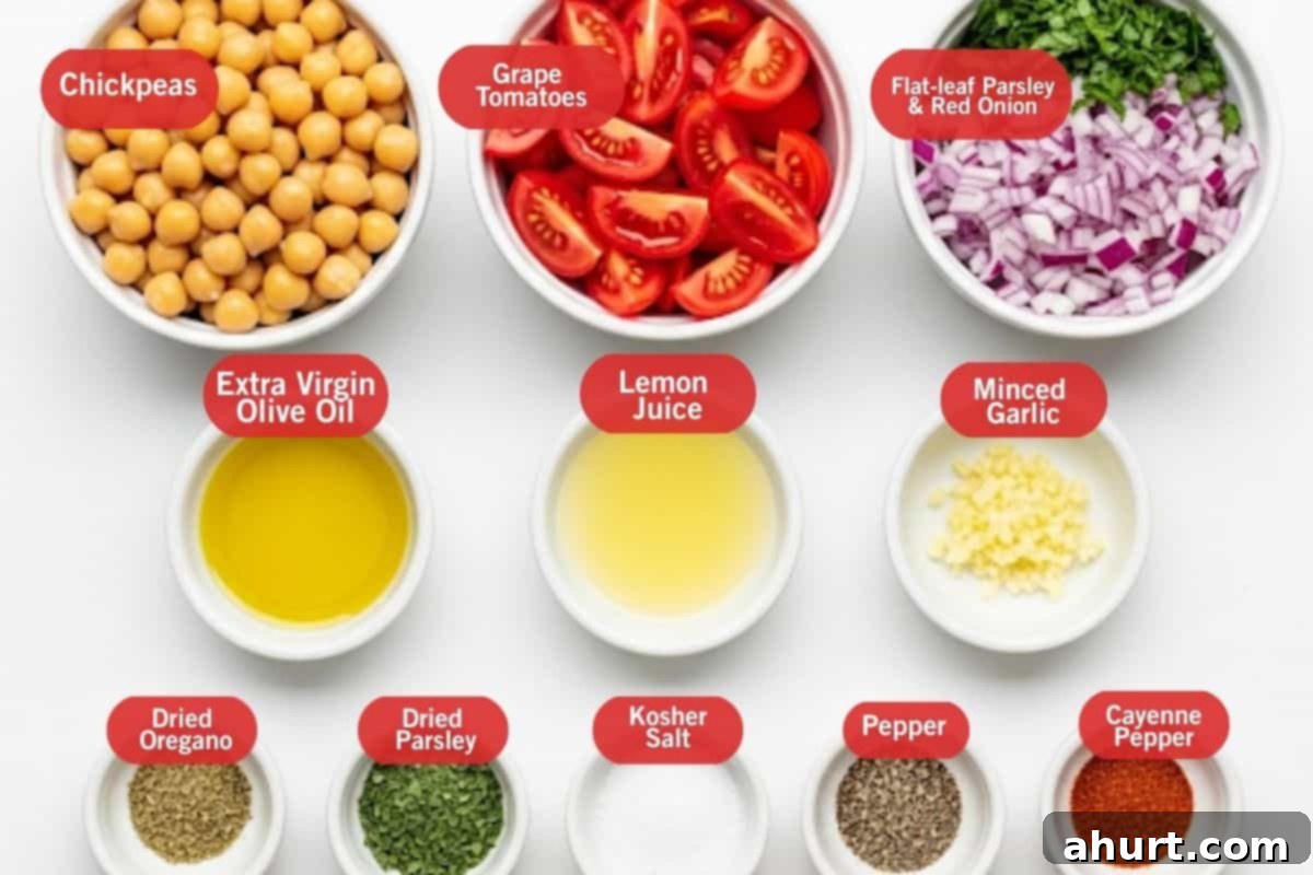Mediterranean Chickpea Tomato Salad 3 Flat lay photo of ingredient shot of chickpeas, grape tomatoes, flat-leaf parsley and red onion, extra virgin olive oil, lemon juice, minced garlic, dried oregano, dried parsley, kosher salt, pepper, cayenne pepper