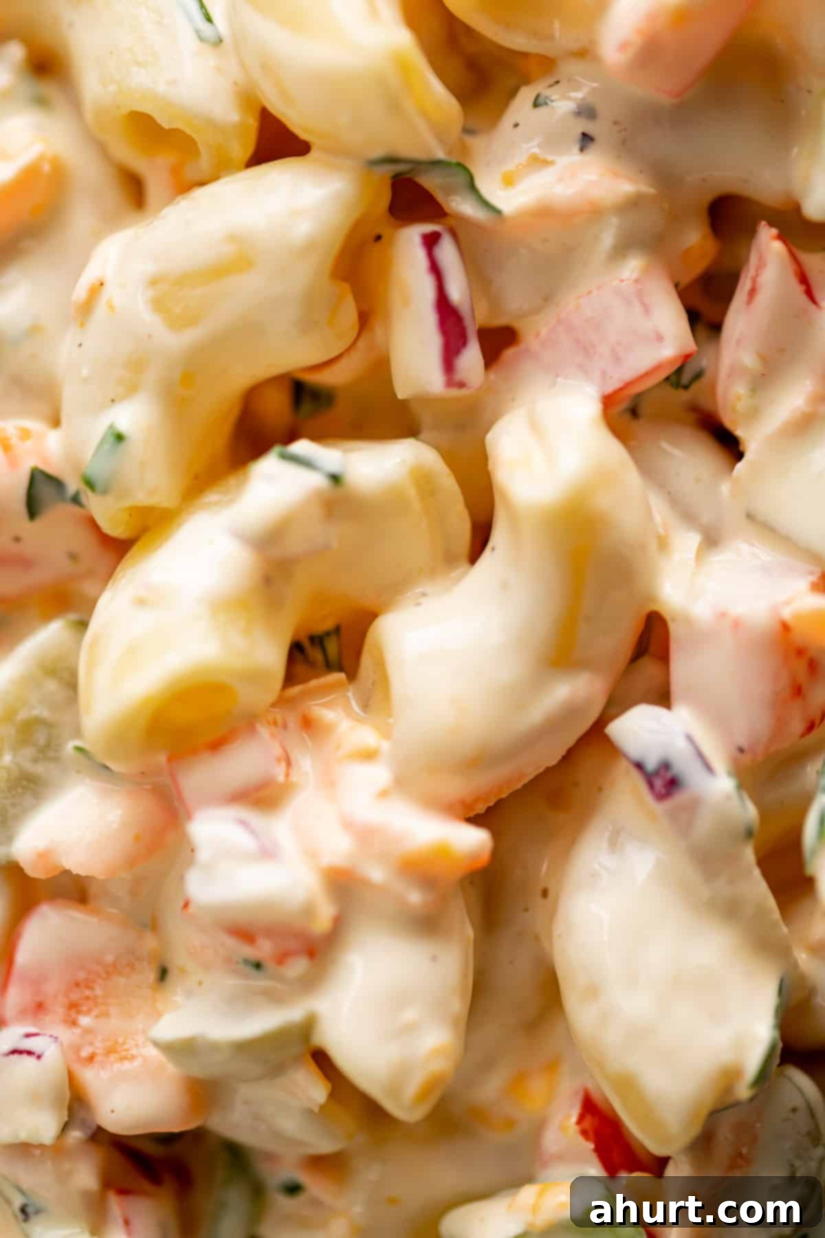 Picnic Perfect Macaroni Salad 3 A close up image of Creamy Macaroni Salad, showcasing its rich texture and fresh ingredients.