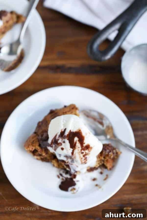 A top-down view of the freshly baked Peanut Butter Chocolate Chip Deep Dish Skillet Cookie, showcasing its round shape and inviting golden-brown surface.