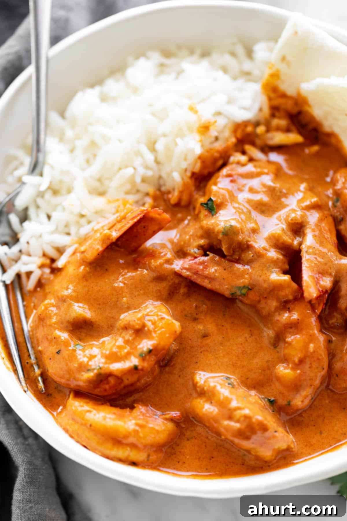 Creamy Coconut Shrimp Curry 4 Shrimp curry served with rice and naan bread in a bowl